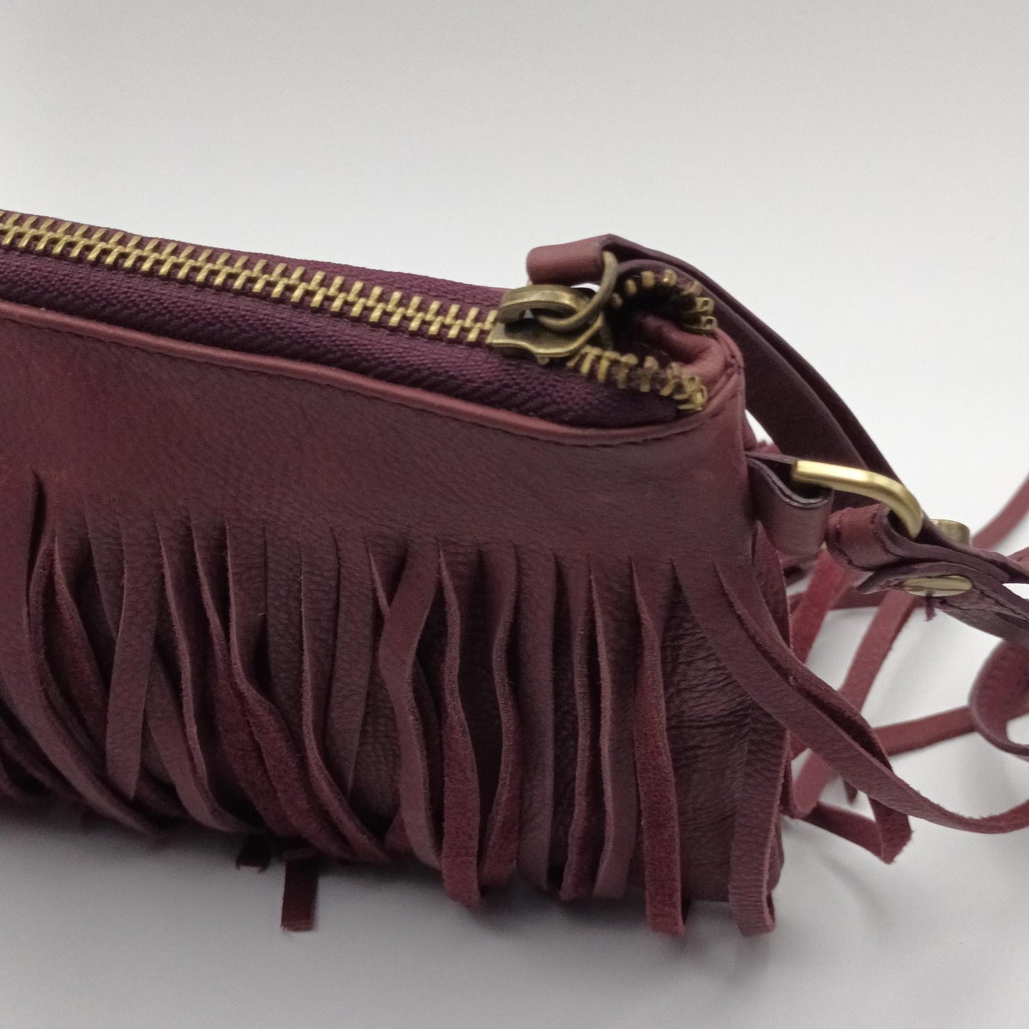 Burgundy fringed leather clutch JAG