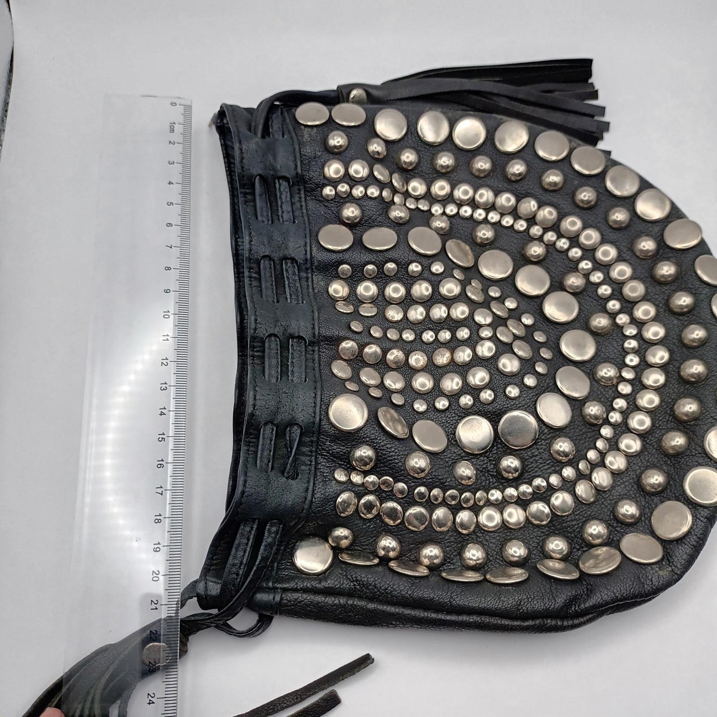 Black leather studded fringed clutch bag