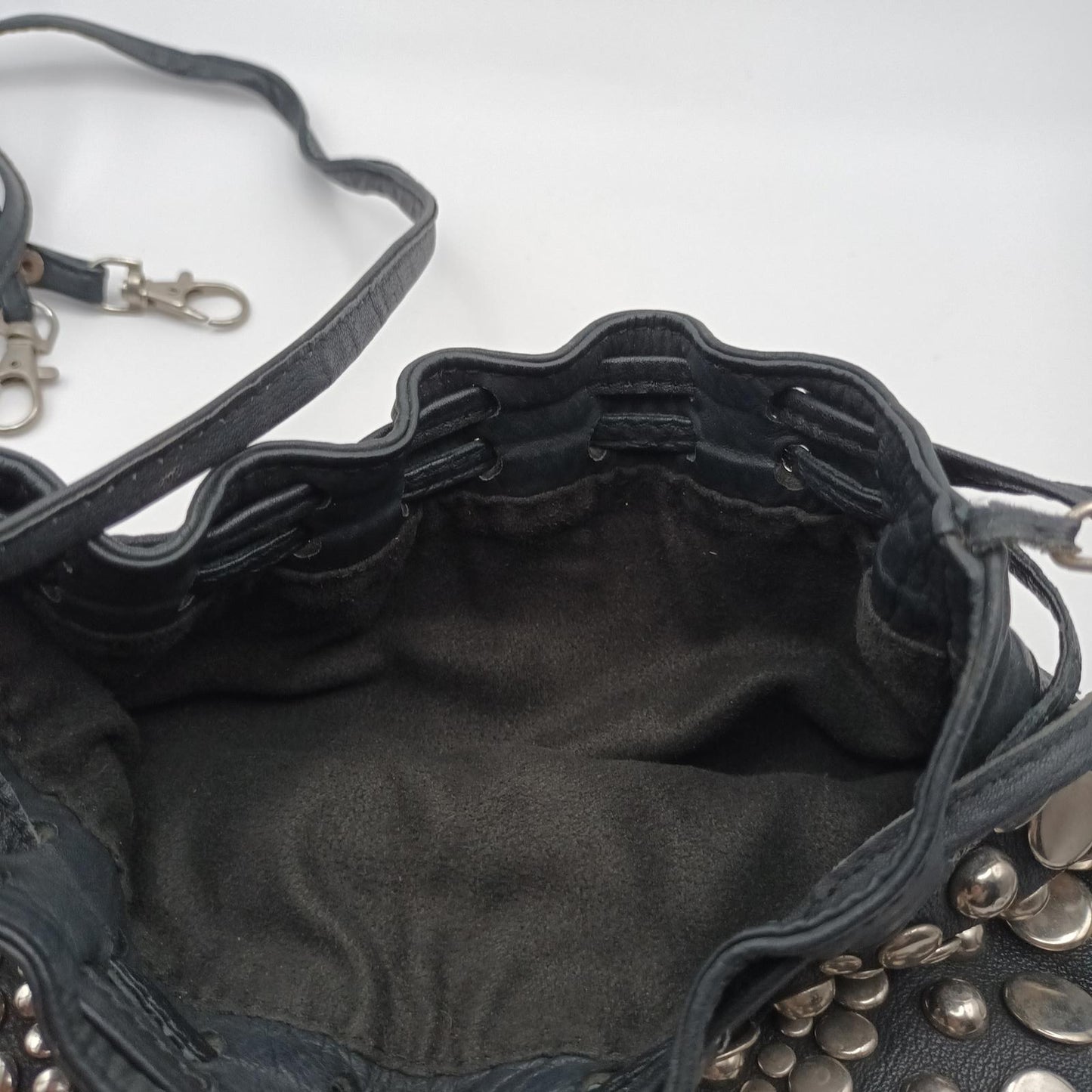 Black leather studded fringed clutch bag