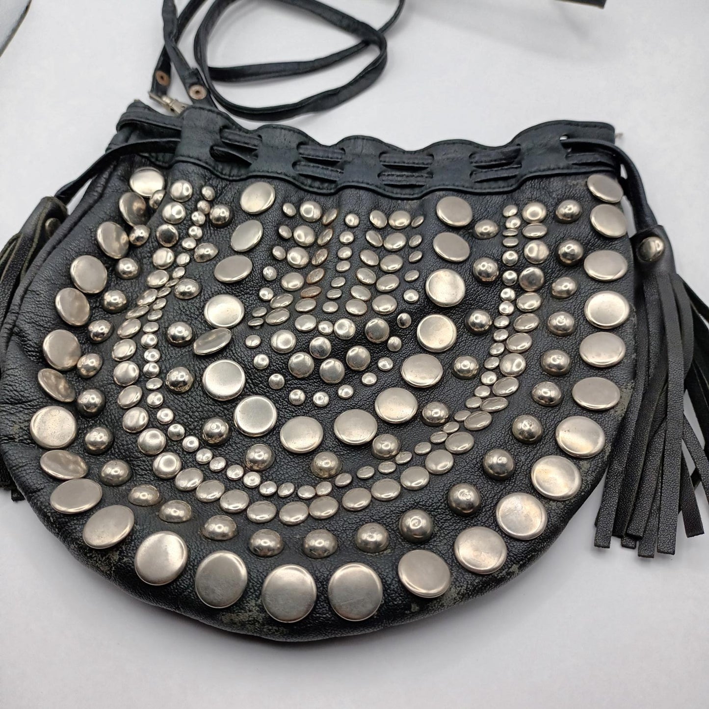 Black leather studded fringed clutch bag
