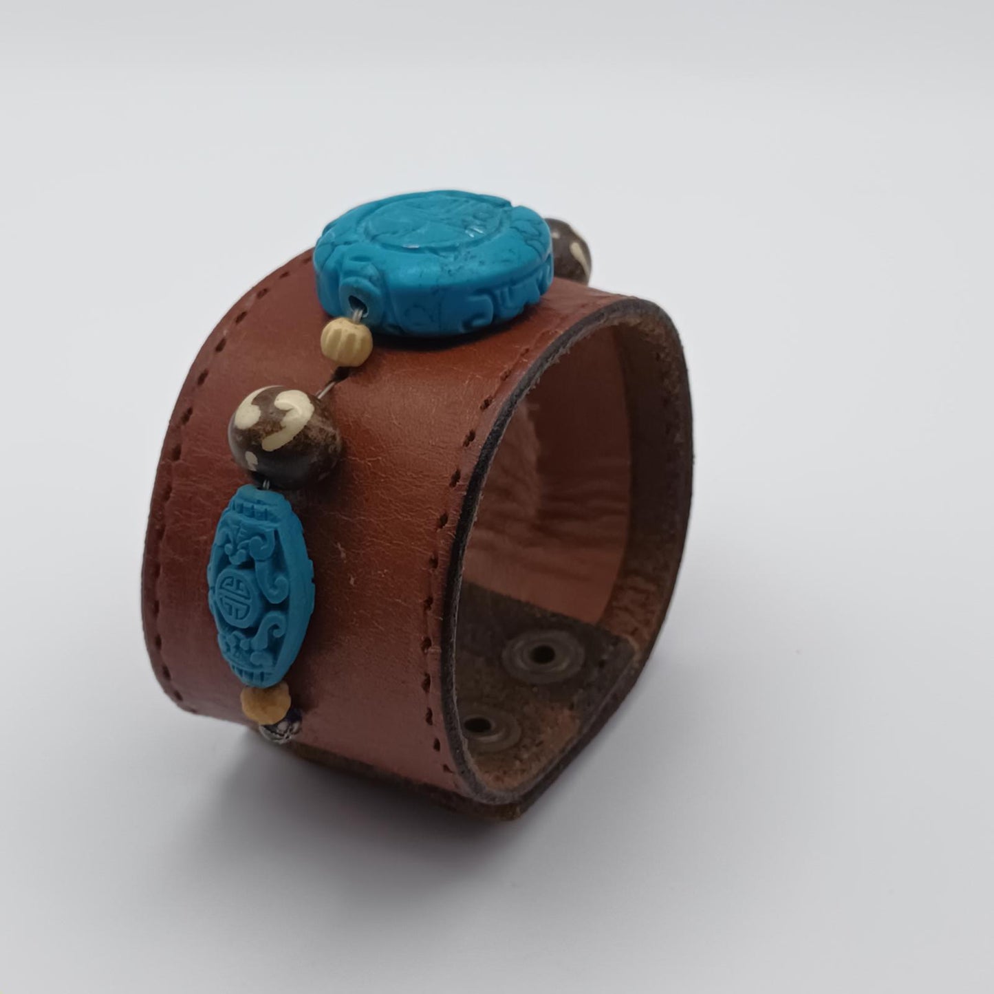 Vintage Handmade brown leather cuff with blue oriental stone embellishments