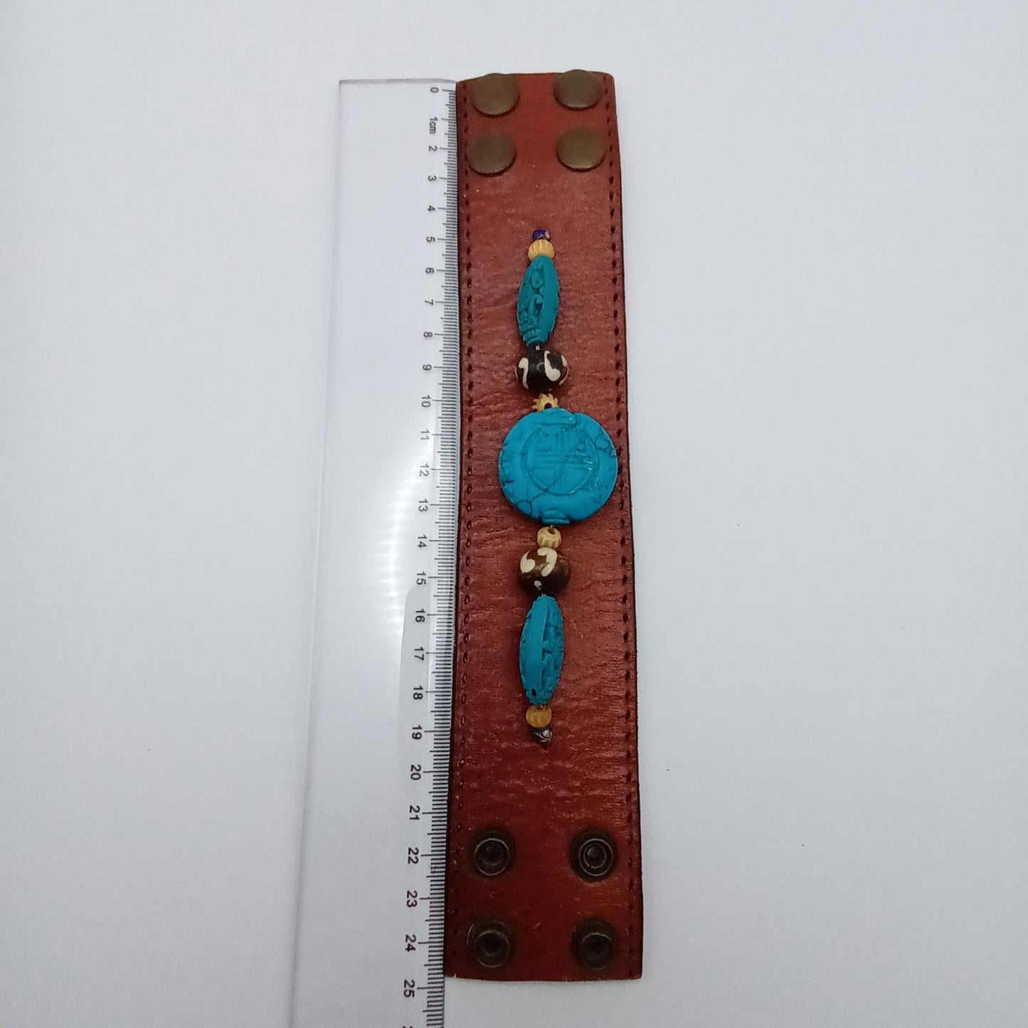 Vintage Handmade brown leather cuff with blue oriental stone embellishments
