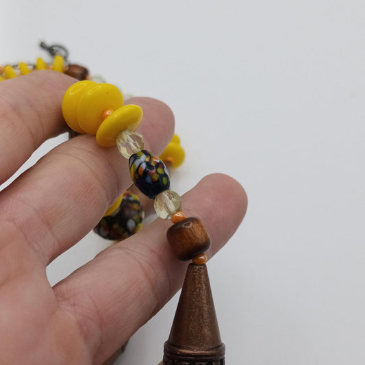 Yellow and bronze beaded necklace with hand painted glass beads.